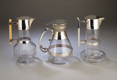 Silver mounted claret jug; electroplate mounted claret jug with aesthetic style decoration to mounts; silver mounted claret jug, all manufactured by Hukin & Heath by Christopher Dresser