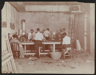Film laboratories at Carlton Motion Picture Co. with five men and one woman working with film, splicing etc., New York by Company Byron