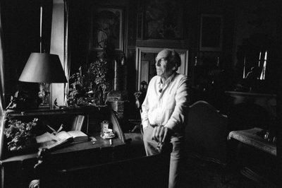 Jiri Mucha Standing by His Desk in His House in Hradcany, Prague by Czech Photographer