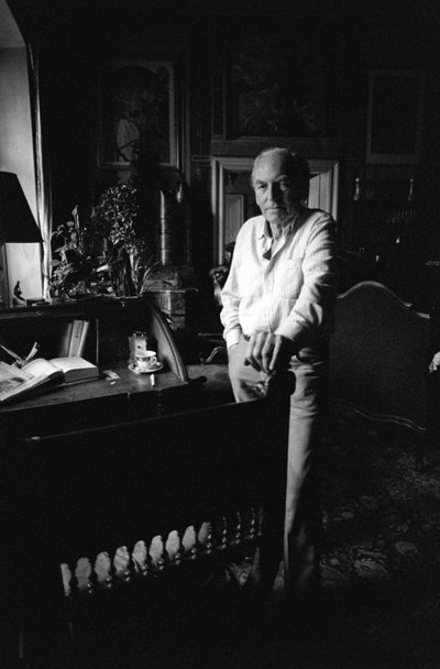 Jiri Mucha Standing by His Desk in His House in Hradcany, Prague by Czech Photographer