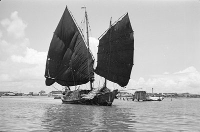 A Bell Stemmed Harbour Junk Under Sail at Singapore by David Watkin Waters
