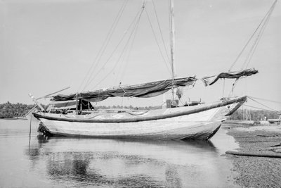 A two-masted Twaqo type junk moored bow-on to the shore at Singapore by David Watkin Waters