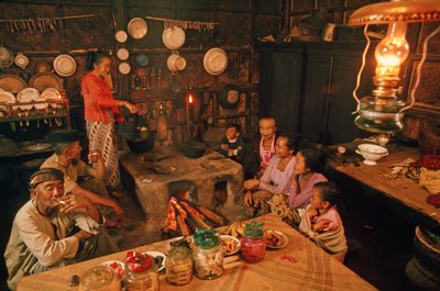 A family sits together before dinner. Tenggerese, Java, Indonesia by Dean Conger