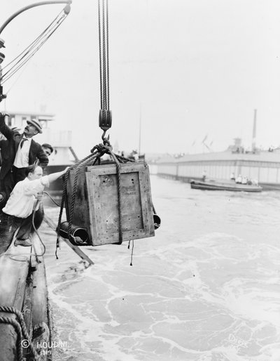 Crate containing Harry Houdini, being lowered into New York Bay, 1912 by Dietz