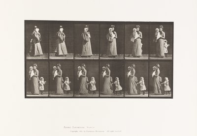 Walking carrying child, turning around; another child holding on to dress by Eadweard Muybridge