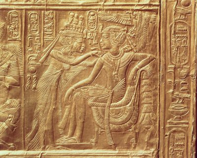 Detail from the little shrine of Tutankhamun depicting the Queen fastening a necklace round the king