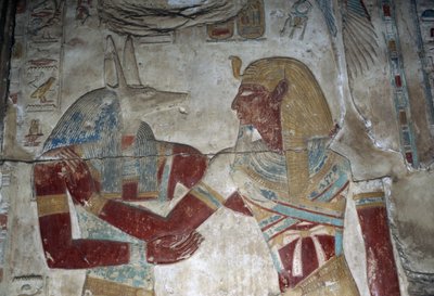 Painted relief depicting Pharaoh and god Anubis, chapel of Osiris, Temple of Seti I by Egyptian 19th Dynasty