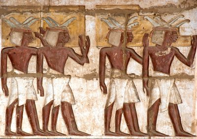Egyptian antiquity: first court, detail of painted reliefs representing a group of Nubians bringing offerings to the pharaoh. Funeral Temple of Ramses III by Egyptian 20th Dynasty