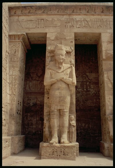 One of the standing figures of Ramesses III as the god Osiris, east side of the first court of the Mortuary Temple of Ramesses III by Egyptian 20th Dynasty