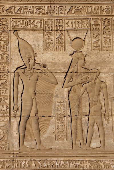 Egyptian Antiquity: Roman Mammisi Commemorating the Birth of Ihy, Son of Hathor - Detail of Reliefs and Hieroglyphs: the Goddess Isis - Hathor Nursing Her Son Ihi (Ihy) and Behind Her Another Image of Ihi with a Finger in Her Mouth Indicating that it is a  by Egyptian Ptolemaic Period