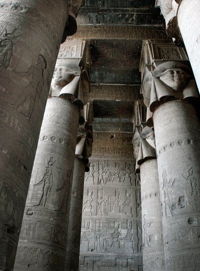 Partial view of the hypostyle room with columns decorated with the representation of the goddess Hathor. Temple of Hathor, Denderah, Egypt by Egyptian Ptolemaic Period