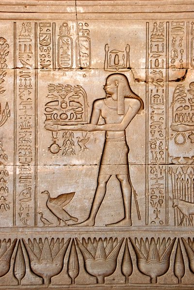 Egyptian antiquity: representation of a man bringing offerings to the goddess, Temple of Hathor, Denderah, Egypt - Egyptian civilization: a man carrying offerings to the goddess Hathor, carved on the wall of Hathor Temple (or Temple of Tentyra) in Denderah by Egyptian Ptolemaic Period