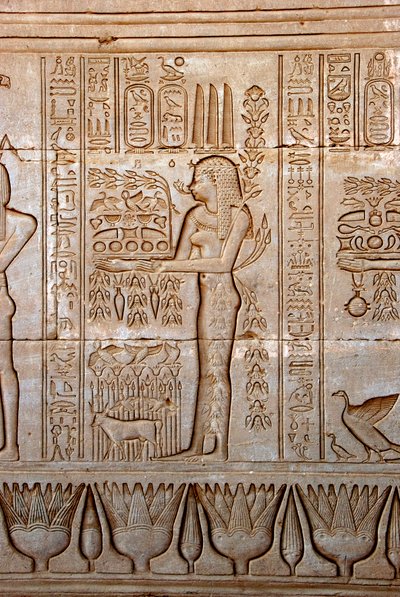 Representation of a young woman bringing offerings as homage to the goddess, Temple of Hathor, Denderah, Egypt by Egyptian Ptolemaic Period