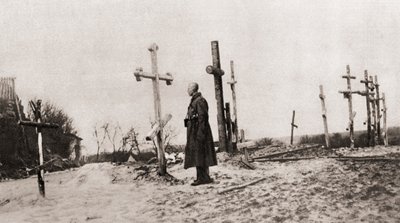 A Russian Soldier at the Grave of a Comrade-in-Arms During World War One, from The Illustrated War News, 1915 by English Photographer