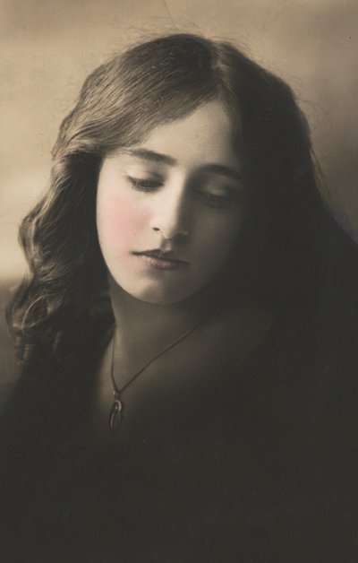 Beautiful girl, with long dark hair, with locket around her neck by English Photographer