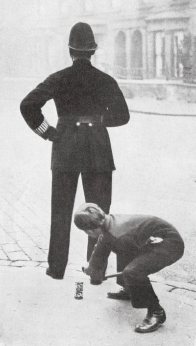 Boy Playing a Prank on a Policeman by English Photographer
