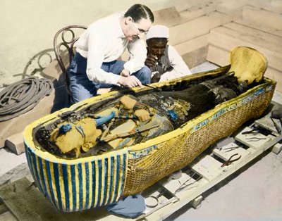 Howard Carter and an Egyptian Assistant Examining the Sarcophagus of King Tutankhamen by English Photographer