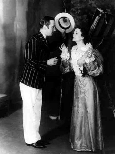 George Curzon as Algernon Moncrieffe (Algy) and Ursula Jeans as Cecily Cardew, in The Importance of Being Earnest, by Oscar Wilde at the Old Vic Theatre, 5 February 1934 by English Photographer