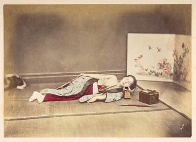 Japanese woman sleeping, Studio portrait of a young Japanese woman sleeping, one breast exposed and with her head resting on a wooden pillow by English Photographer