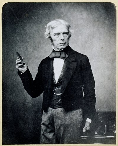 Michael Faraday holding a Bar Magnet by English Photographer