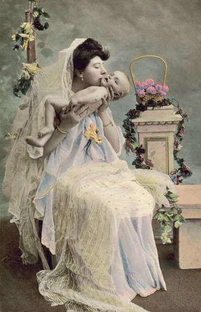 Mother kissing baby by English Photographer