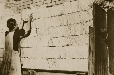 Stacking unleavened bread for the Passover in a Hebrew bakery by English Photographer