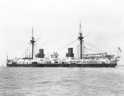 View of the ironclad battleship HMS Inflexible (launched 1876) pictured after conversion to military rig in 1885 by English Photographer