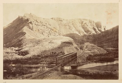 Views on the Pacific Railway, of railway track crossing a river on a girder bridge, with mountains beyond by English Photographer