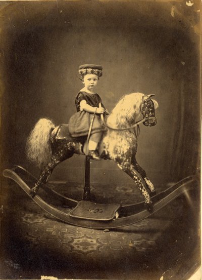 Young Girl Seated on a Dappled Rocking Horse by English Photographer
