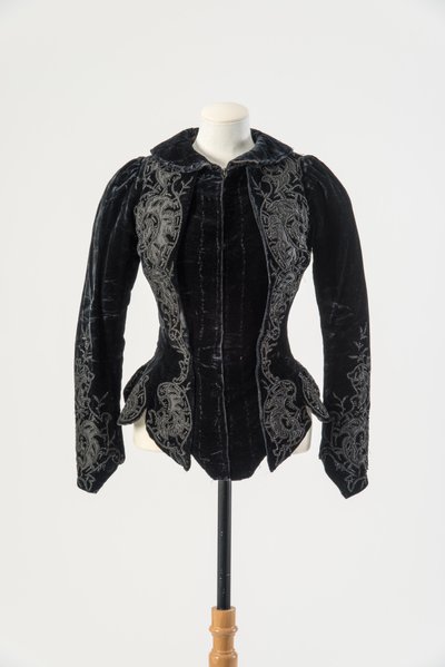 Black velvet jacket embroidered with applied black silk and metal beads, late 1890s by English School