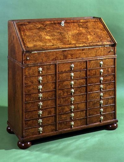 Bureau with many small drawers and bun feet by English School