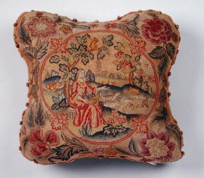 Cushion, embroidered in petit point, depicting a woman in a landscape by English School