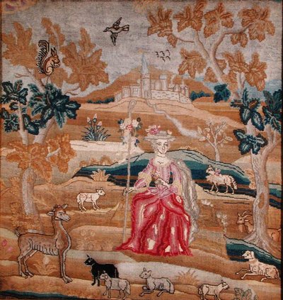 Embroidered panel depicting a shepherdess in front of a village by English School