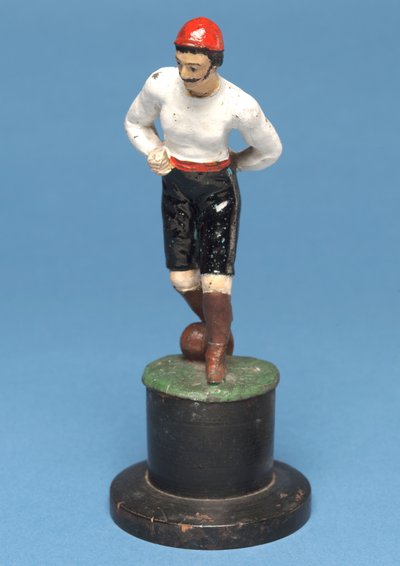 Footballer with the ball at his feet by English School