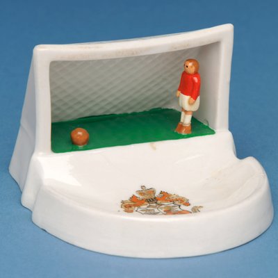Rare armorial souvenir of Douglas, Isle of Man, showing a goalkeeper in his goal (ceramic) by English School