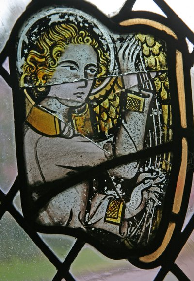 Window in the Cloisters depicting a musician angel with a harp by English School