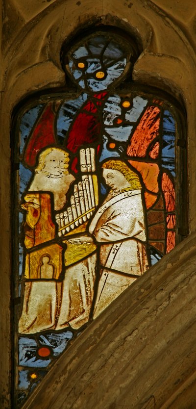 Window depicting musician angels, one with a portative organ by English School