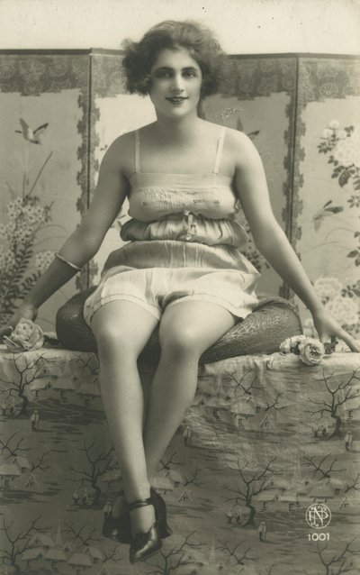 Portrait of a seated woman in her underwear by European Photographer