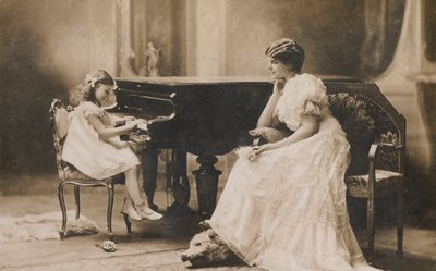 Portrait of a woman watching a young girl playing the piano by European Photographer