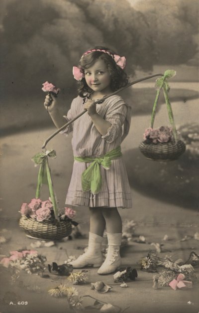 Portrait of a young girl carrying baskets of flowers by European Photographer