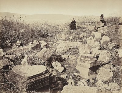 A monk and a man with a gun pose, sitting on some ruins, near Capharnaum by Félix Bonfils