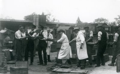 A 20 ft. long Python being carried by eleven members of the Zoological Society staff, London Zoo, June 1925 by Frederick William Bond
