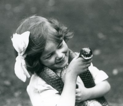 A Young Girl Betty Holding an Eastern Indigo Snake, London Zoo, 1924 by Frederick William Bond