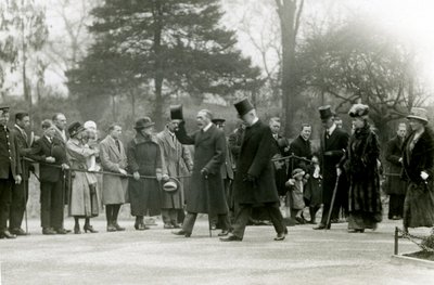 King George V raising his hat to the crowds at the front of his entourage, during a visit to London Zoo to officially open the Aquarium, April 1924 by Frederick William Bond