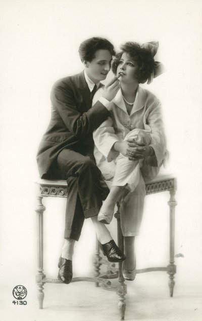 Androgynous Man in Suit Applying Lipstick to Lips of Girl in Pajamas by French Photographer