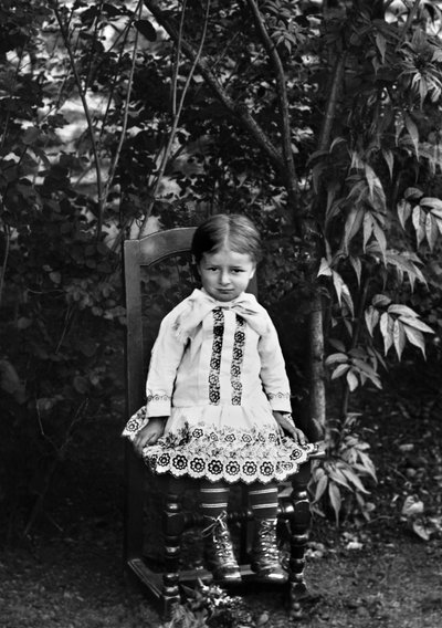 Portrait of a little girl from Bourmont in Haute Marne, sitting in the garden of the Abbey of Septfontaines. Photography late 19th century. Ducos Collection. by French Photographer