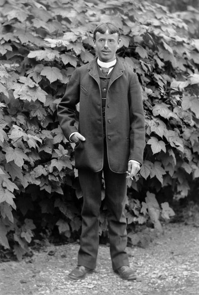 Young man has a cigarette, employed as a man to do everything, posing in the garden of the Abbey of Septfontaines, near Bourmont in Haute-Marne, around 1880. Photography. Ducos Collection. by French Photographer