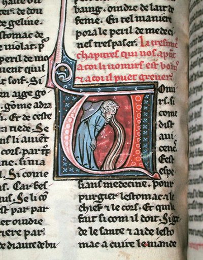 Historiated initial depicting a man vomiting by French School