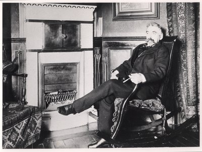 Stephane Mallarme (1842-98) seated by the fireplace at his home on Rue de Rome, Paris by French School