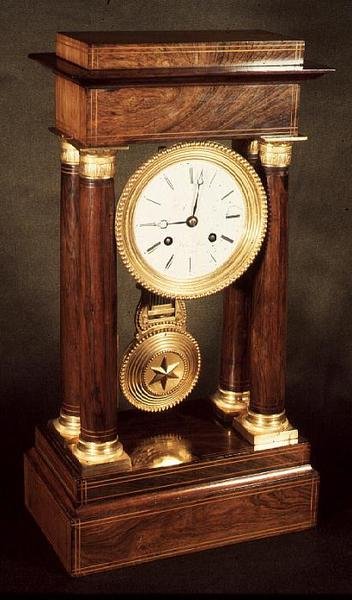 Table clock, polished wood pillars and entablature, French, First Empire period, early 19th century by French School